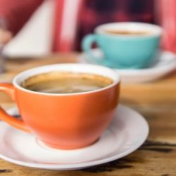 shallow-focus-photo-of-orange-ceramic-mug-on-white-saucer-1058918